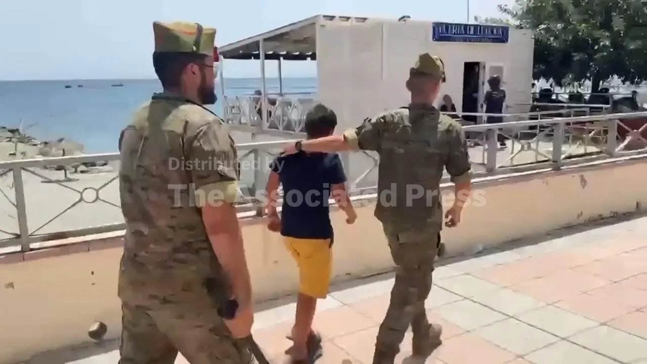 Spanish Soldiers Assist Crying Moroccan Boy at Ceuta Border Amidst Repatriation Controversy